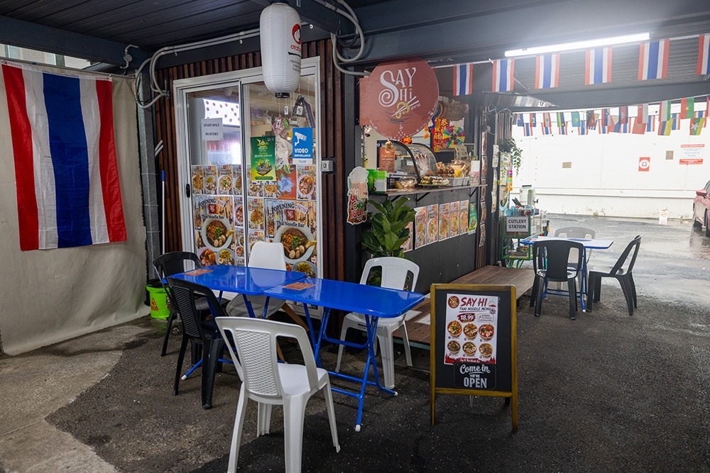 The Say Hi stall lit up at night in the laneway